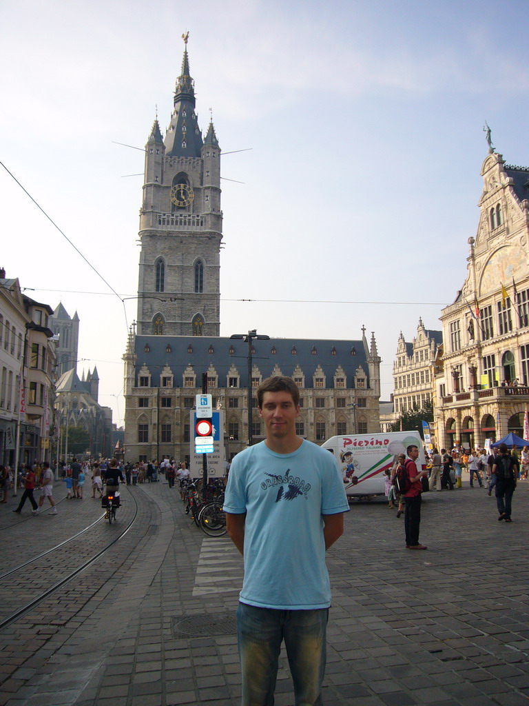Tim at the Sint-Baafsplein square with a view on the Belfry of Ghent, the Lakenhalle building, the NTGent Theatre and the Sint-Niklaaskerk church