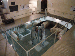 Statues and excavated walls at the Secrecy Room in the basement of the Belfry of Ghent