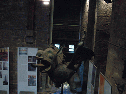 Dragon statue and gate at the Tower Keepers Room at the first floor of the Belfry of Ghent, viewed from the staircase to the second floor