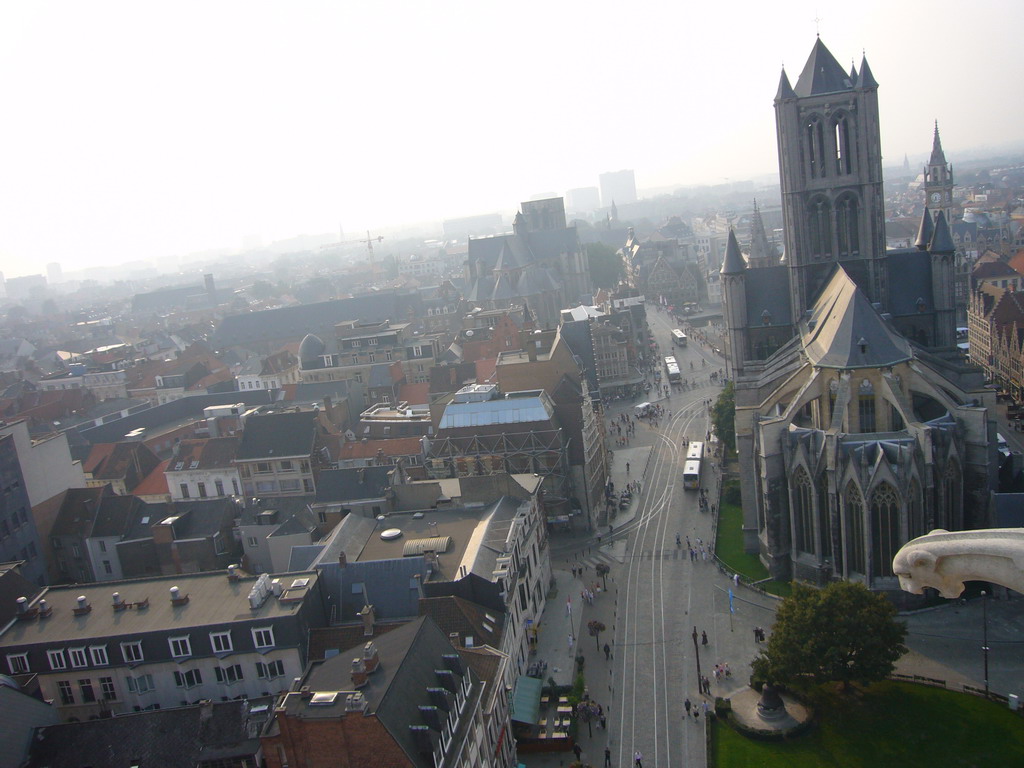 Gargoyle and the city center with the Sint-Niklaaskerk church and the Sint-Michielskerk church, viewed from the walkway at the fourth floor of the Belfry of Ghent