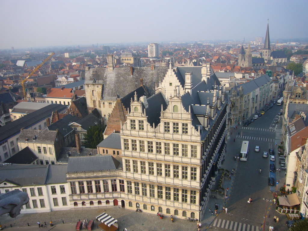 Gargoyle and the city center with the City Hall, the Botermarkt square and the Sint-Jacobskerk church, viewed from the walkway at the fourth floor of the Belfry of Ghent