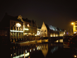 The Kleine Vismarkt bridge over the Leie river and the Groot Vleeshuis building, viewed from the Kraanlei street, by night