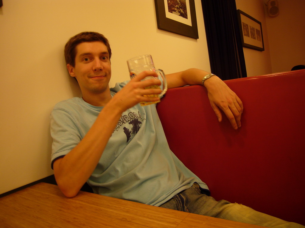 Tim with a Maes beer in a restaurant in the city center