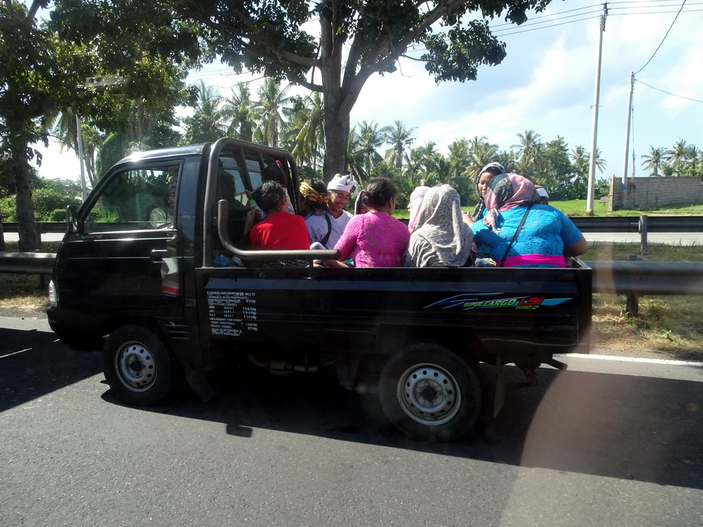 Car filled with people at the Jalan Prof. Dr. Ida Bagus Mantra street at Sukawati, viewed from the taxi