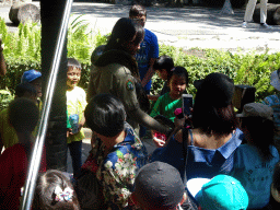 Zookeeper with a snake walking through the audience at the Hanuman Stage at the Bali Safari & Marine Park, during the Animal Show