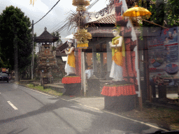 Gate of a temple at the at the Jalan A. A. Gede Rai street, viewed from the taxi to Ubud
