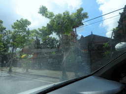 Temple at the Jalan A. A. Gede Rai street, viewed from the taxi to Ubud