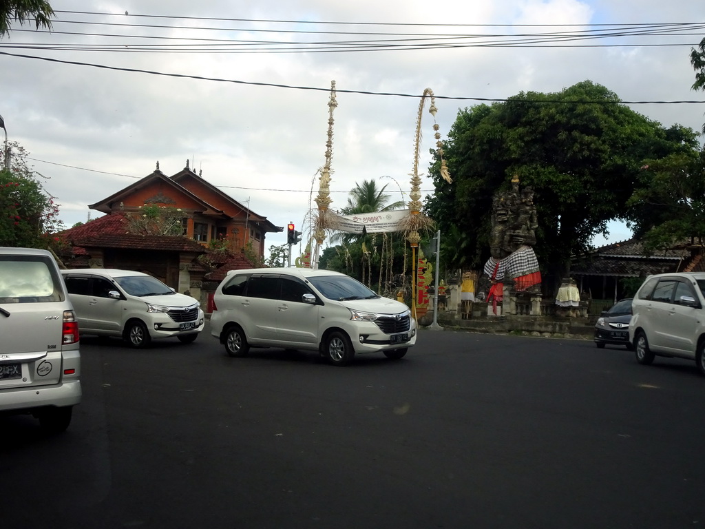 Statue and decorations at the Jalan Raya Batuan street, viewed from the taxi from Ubud