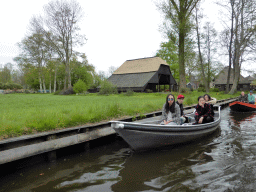 Tourists in a boat on the canal along the Dominee T.O. Hylkemaweg street, viewed from our tour boat