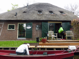 Boat and the front of a house at the canal along the Dominee T.O. Hylkemaweg street, viewed from our tour boat