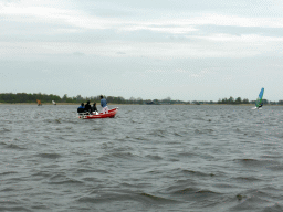 Boats with tourists and a surfer on the Bovenwijde lake, viewed from our tour boat