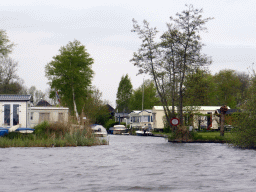 Boats and holiday houses at the banks of the Bovenwijde lake, viewed from our tour boat