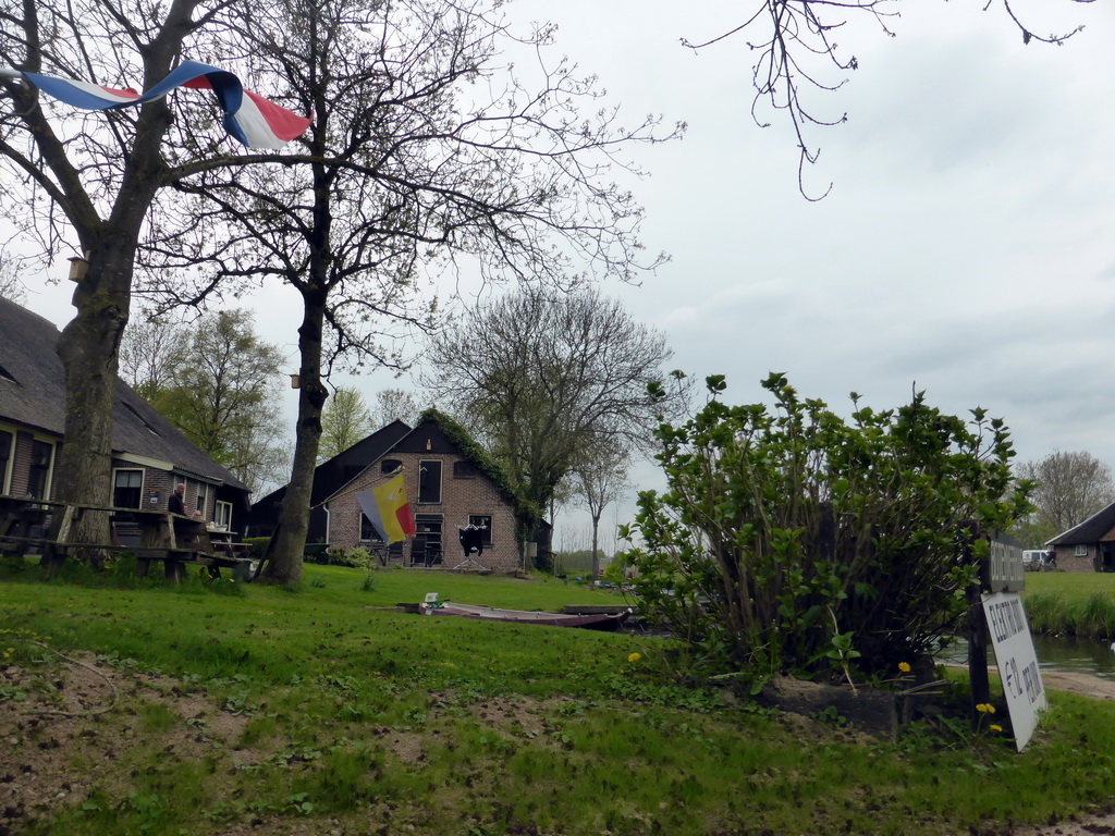 Houses with flags at the Binnenpad canal, viewed from our tour boat