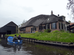 Houses and boat at a canal, viewed from our tour boat on the Binnenpad canal