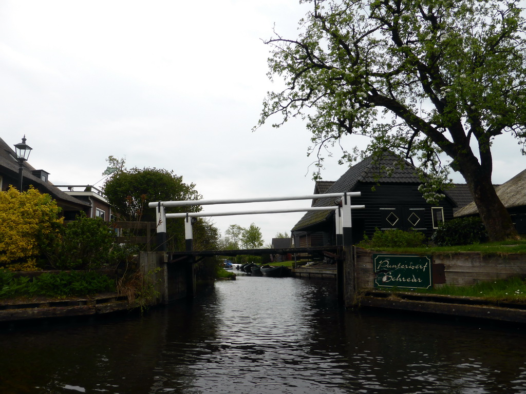 Houses, boats and a bridge over a canal, viewed from our tour boat on the Binnenpad canal