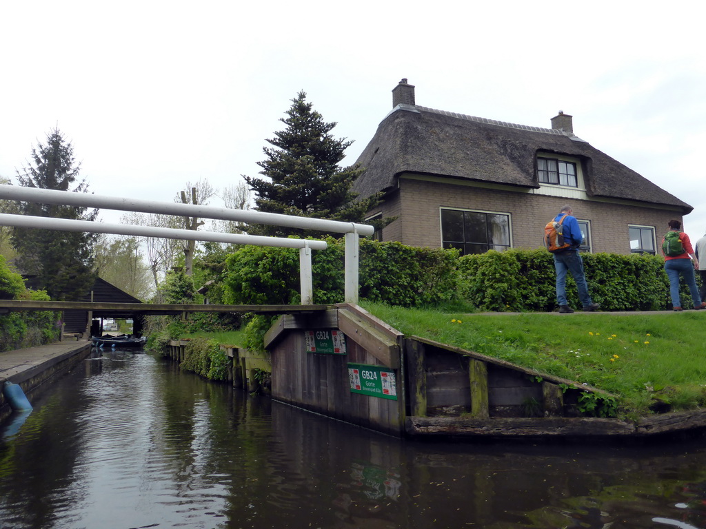 Houses, boats and a bridge over a canal, viewed from our tour boat on the Binnenpad canal