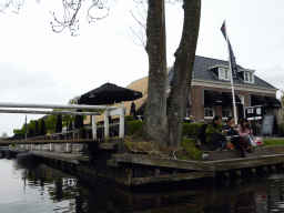 The Brasserie De Grachthof restaurant, boats and a bridge over a canal, viewed from our tour boat on the Binnenpad canal
