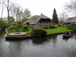 Boat in the Binnenpad canal and a house with camel roof