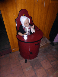 Children`s seat with wax statue at the Woonkamer room of the `t Olde Maat Uus museum