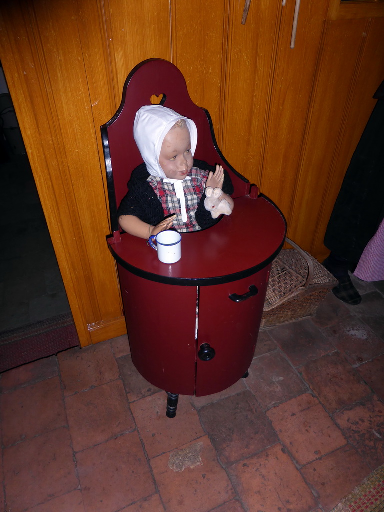 Children`s seat with wax statue at the Woonkamer room of the `t Olde Maat Uus museum