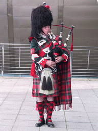 Piper in front of the Scottish Exhibition and Conference Centre