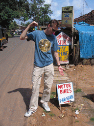 David with a sign on the road at Colva