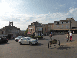 Roundabout in the town center with a monument for the victims of World War I, and the front of the Chapelle des Penitents Blancs chapel