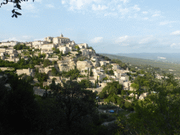 The southwest side of town with the Château de Gordes castle and the Église Saint Firmin church, viewed from a parking place next to the Route de Cavaillon