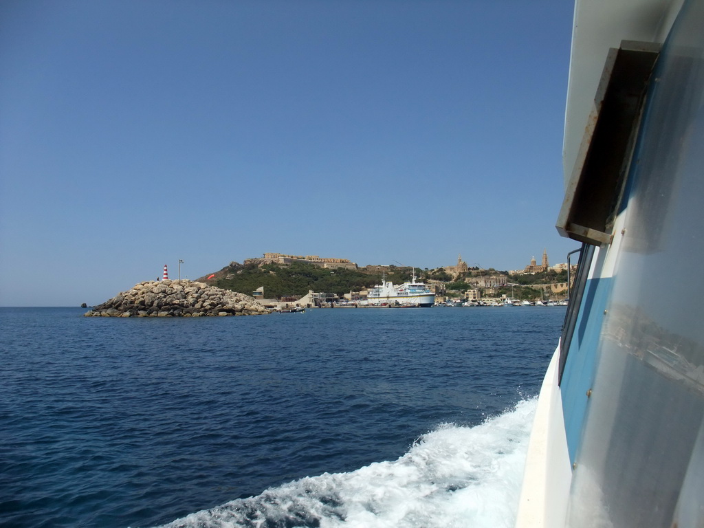Mgarr Harbour, Fort Chambray and the town of Ghajnsielem with the Ghajnsielem Parish Church, viewed from the Luzzu Cruises tour boat from Malta to Gozo