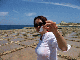 Miaomiao with salt in her hand at the salt pans at Xwejni Bay