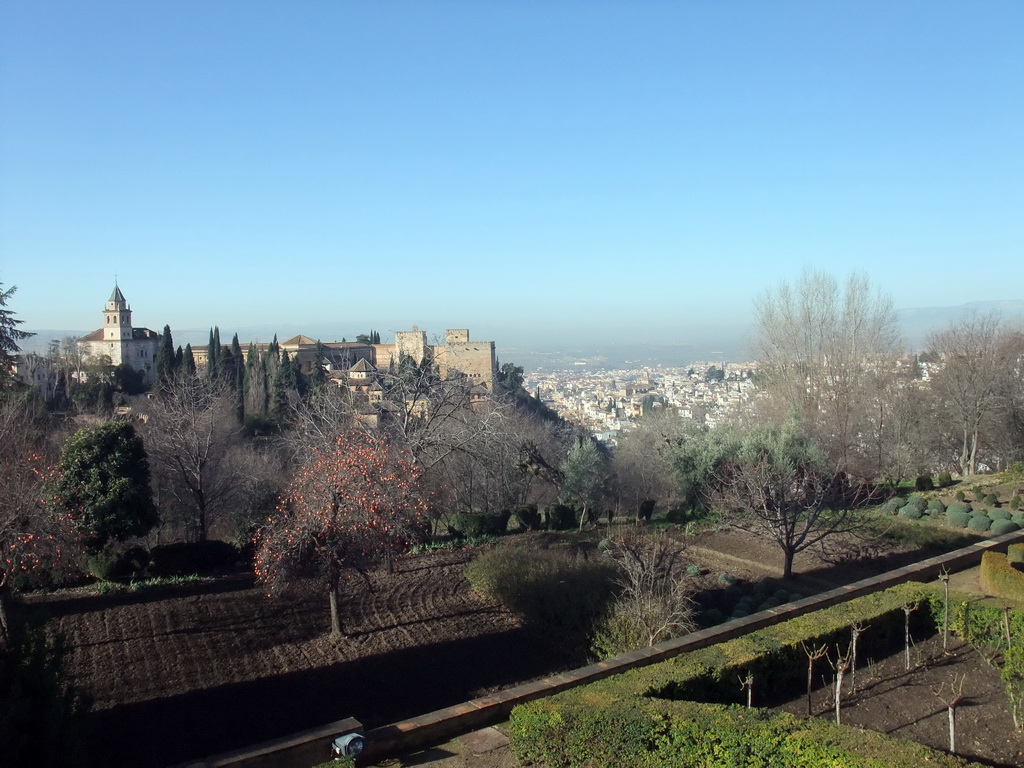 The Alhambra palace and the city of Granada, viewed from the Patio de la Acquia courtyard at the Palacio de Generalife