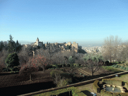 The Alhambra palace and the city of Granada, viewed from the Patio de la Acquia courtyard at the Palacio de Generalife