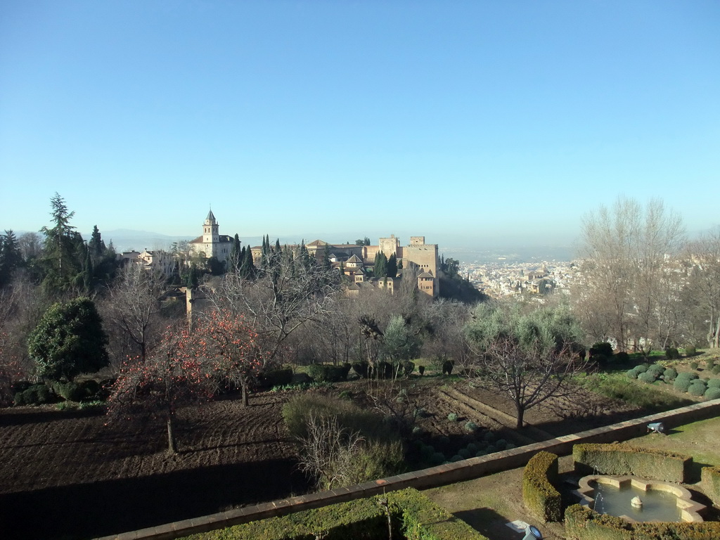 The Alhambra palace and the city of Granada, viewed from the Patio de la Acquia courtyard at the Palacio de Generalife