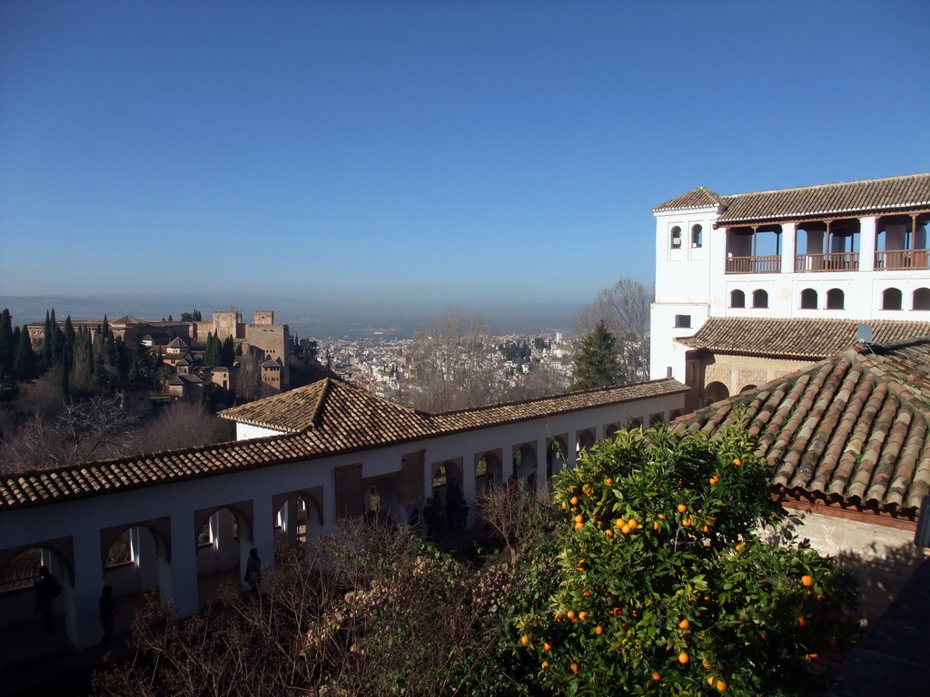 The Alhambra palace, the city of Granada, the Patio de la Acquia courtyard and the Pabellón Norte, viewed from the Jardines Altos gardens at the Palacio de Generalife