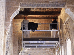 Renovation workers at a wall of the Patio de los Leones courtyard at the Alhambra palace