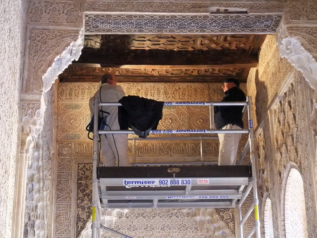 Renovation workers at a wall of the Patio de los Leones courtyard at the Alhambra palace