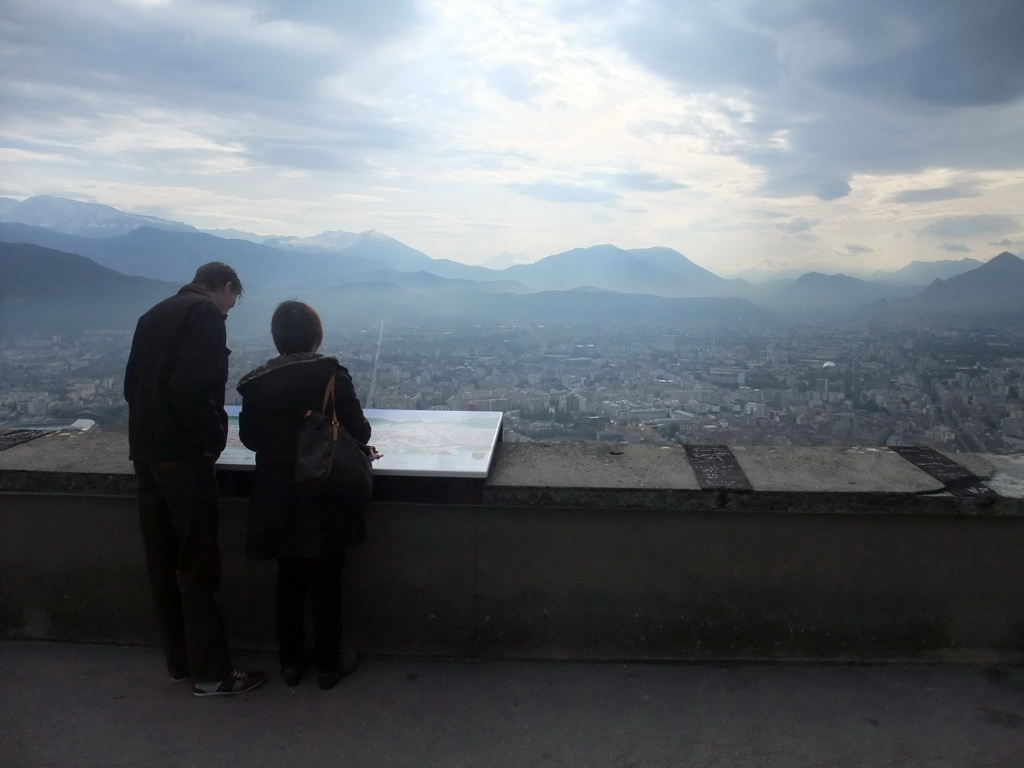 Miaomiao and David at the top of the Bastille, with a view on the city center