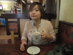 Miaomiao with coffee in the restaurant `Relais du Château`