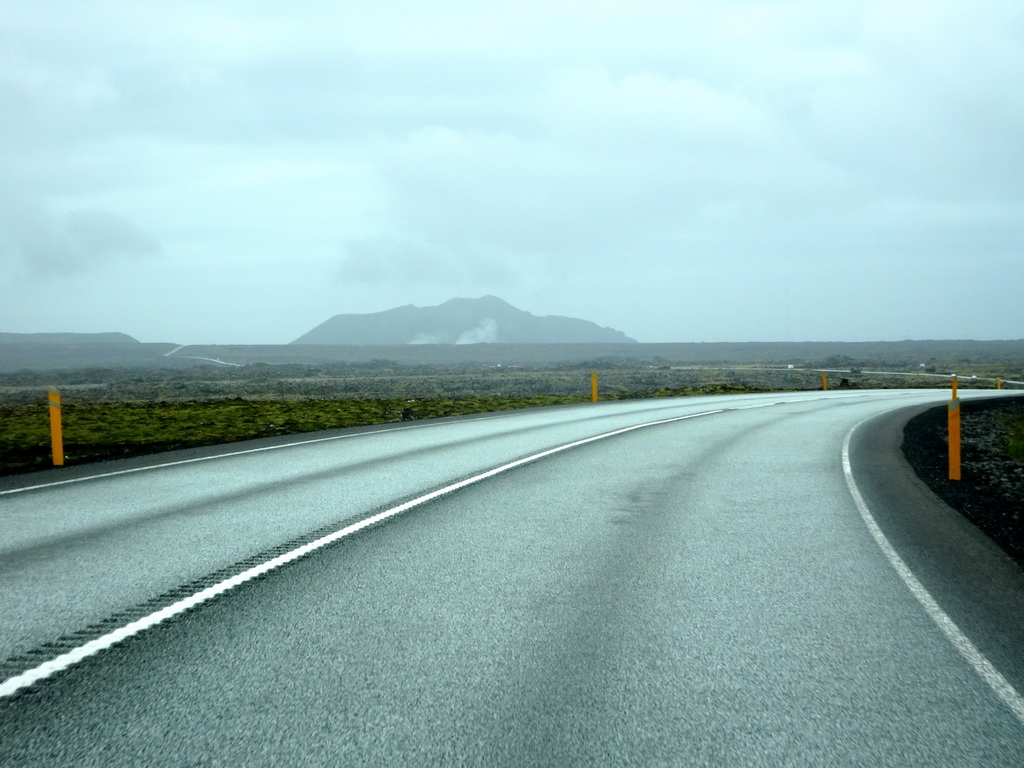 The Grindavíkurvegur road and smoke from the Svartsengi Power Station and the Blue Lagoon geothermal spa, viewed from the rental car