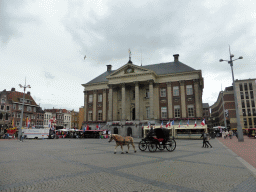 Front of the City Hall, a horse and carriage and market stalls at the Grote Markt square