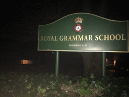Sign in front of the Royal Grammar School at High Street, by night