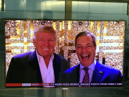 TV screen with an image of Donald J. Trump and Nigel Farage, at Terminal 4 of London Heathrow Airport