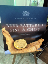 Poster of Beer Battered Fish & Chips in front of the Prince of Wales restaurant at Terminal 4 of London Heathrow Airport