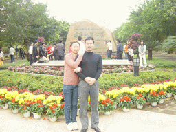 Miaomiao`s family members in front of a rock with inscriptions at the entrance to the Hainan Volcano Park