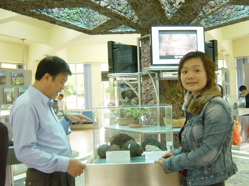 Miaomiao and her father with small volcanic rocks at the museum of the Hainan Volcano Park