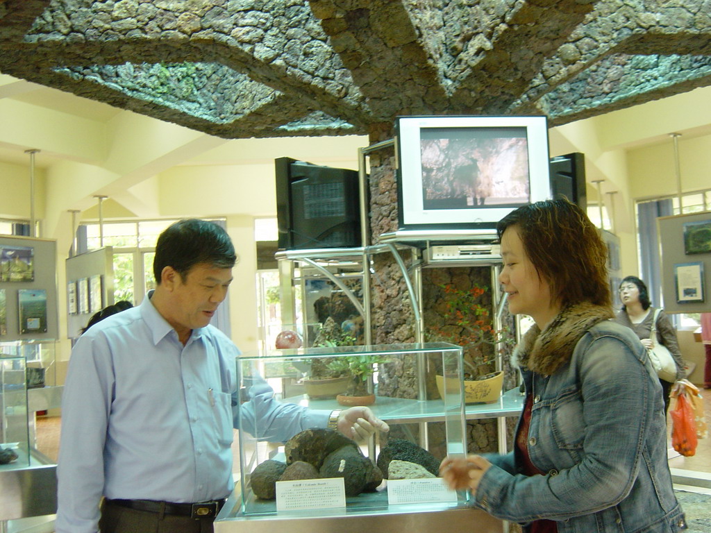 Miaomiao and her father with small volcanic rocks at the museum of the Hainan Volcano Park