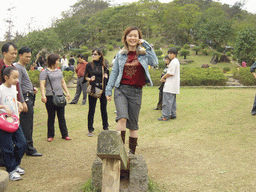 Miaomiao at the old village at the Hainan Volcano Park, with a view on the front of Mt. Fengluling volcano crater