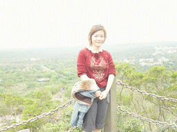 Miaomiao at the top of the Mt. Fengluling volcano crater at the Hainan Volcano Park, with a view on the surrounding area