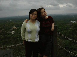 Miaomiao and her sister at the top of the Mt. Fengluling volcano crater at the Hainan Volcano Park, with a view on the surrounding area