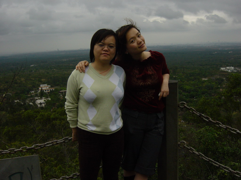 Miaomiao and her sister at the top of the Mt. Fengluling volcano crater at the Hainan Volcano Park, with a view on the surrounding area